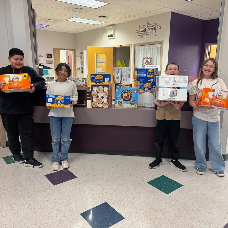 Students at Miller Elementary holding boxes of snacks
